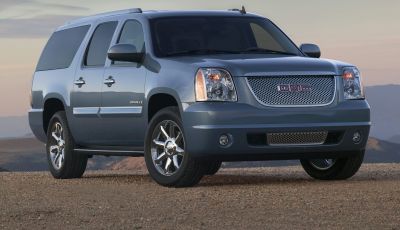 Full-size SUV with mesh grille, chrome wheels, and tinted windows