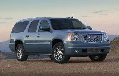 Full-size SUV with chrome grille and wheels, extended body, and rugged design.