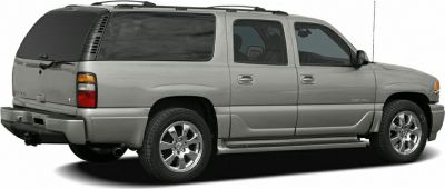 Side profile showing extended body and chrome wheels of a full-size SUV.