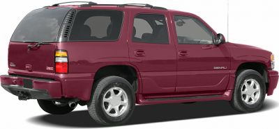 Rear side view of red full-size SUV with alloy wheels