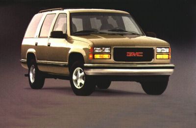 Front angled view of a classic beige SUV with boxy design and 3-door configuration