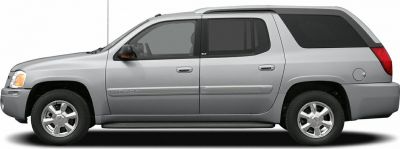 Side profile of a silver extended SUV with four doors and alloy wheels.