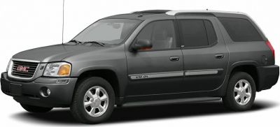 Side view of gray SUV with extended rear cargo area and roof rails.