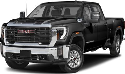 Front angled view of heavy-duty pickup with large black grille and extended tow mirrors