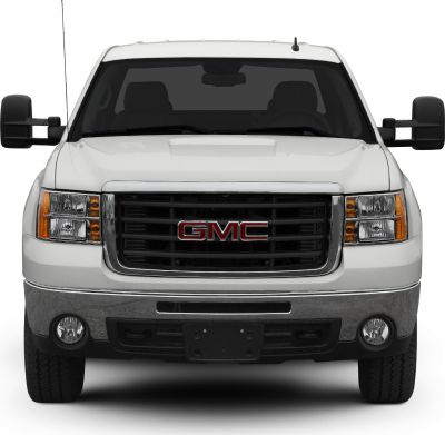 Front view with bold grille, dual stacked headlights, and wide side mirrors