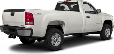 White heavy duty pickup truck with regular cab and long box, 4x4 drivetrain.