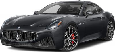 Sleek headlights and sporty multi-spoke alloy wheels with red brake calipers on luxury coupe.