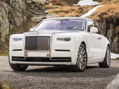 Luxury sedan front with iconic chrome grille and LED headlights