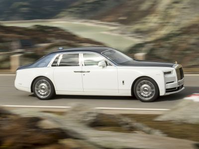 Luxury sedan with two-tone paint and iconic grille in side profile