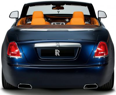 Rear view of a convertible with bright orange seats and dual exhaust pipes