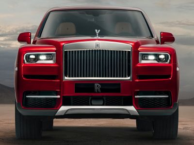 Luxury SUV front with iconic Rolls-Royce grille and Spirit of Ecstasy ornament.