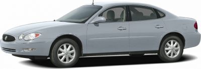 Side profile of a four-door sedan with aerodynamic shape and silver paint.