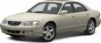 Front side view of a 1993 midsize sedan with distinct headlight and five-spoke wheels