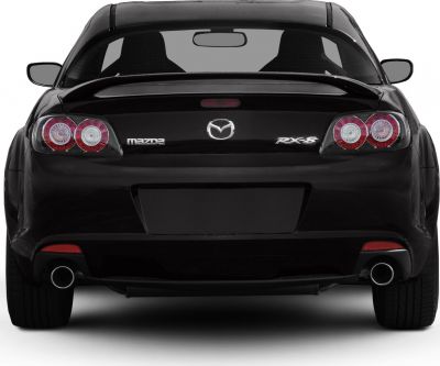 Rear view with distinctive tail lights, dual exhaust, and rear spoiler