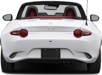 Rear view of a convertible with round taillights and dual exhaust pipes
