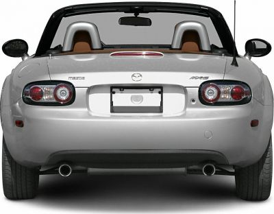 Rear view with dual exhaust and round taillights of a hardtop convertible roadster