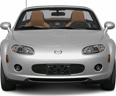 Front view of a roadster featuring dual headlights and tan leather seats