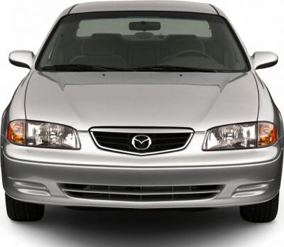 Front view of silver sedan with distinct headlights and Mazda emblem