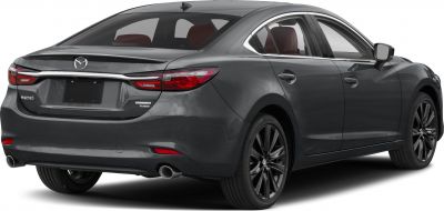 Sleek sedan rear with dual exhausts and distinctive LED tail lights.