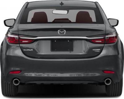 Rear view with slim tail lights, dual exhausts, and rear emblem