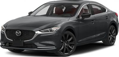 Front angle of metallic gray sedan with LED headlights and alloy wheels