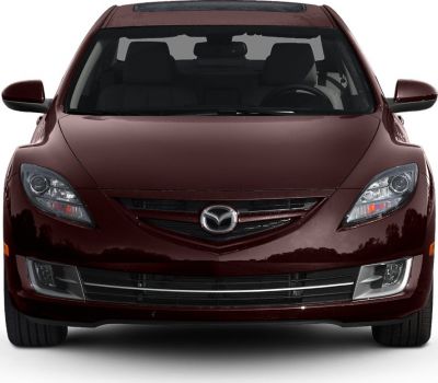 Front view focused on headlights, grille, and bumper of a burgundy sedan