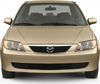 Front view of a beige sedan with distinctive headlights and grille.