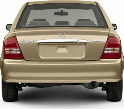 Rear view of sedan with tail lights and chrome trunk handle