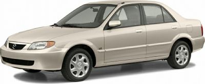 Front side view of a beige four-door sedan with alloy wheels.