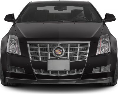 Close-up of a car front with distinctive grille and dual round headlights