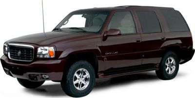 Front-side view of a luxury full-size SUV with tall body and chrome wheels