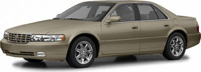 Front and side view of sedan with distinctive grille and chrome wheels