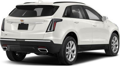 Rear view of a white SUV with vertical taillights and dual exhaust outlets
