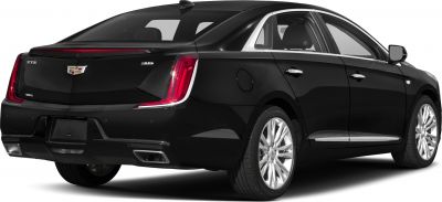 Rear 3/4 view of black sedan with LED vertical taillights and dual exhaust