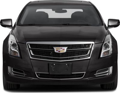 Front view of luxury sedan featuring grille and headlights