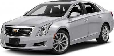 Front-side view of a silver sedan with sharp headlights and multi-spoke alloy wheels