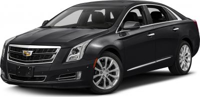 Front-side view of a sedan with chrome grille and sharp headlights