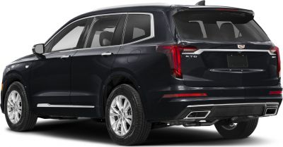 Rear side view of luxury SUV with chrome trim and dual exhaust