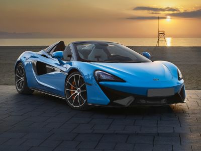 Blue convertible sports car with sharp headlights and orange brake calipers.