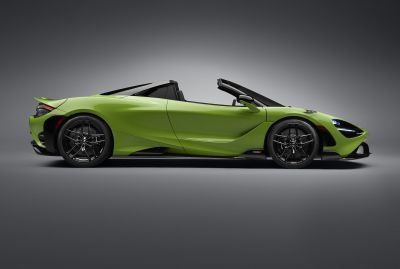 Side profile of a bright green convertible sports car with aerodynamic design and lightweight features.