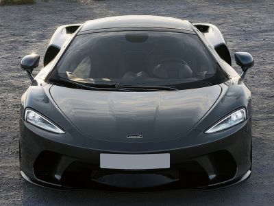Front view of aerodynamic sports car with sleek LED headlights