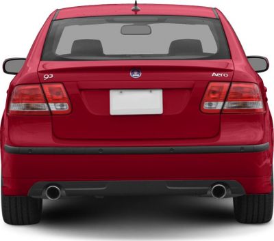 Rear view showing dual exhausts, Aero badge, and taillights on red sedan.