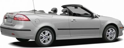 Silver convertible with open top showing rear side and alloy wheels