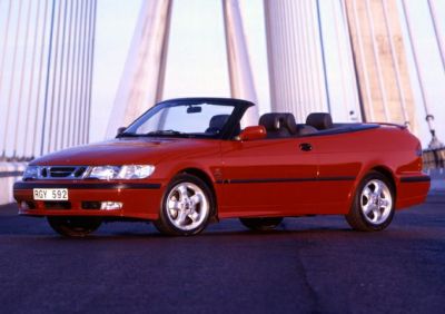 Red convertible with open top and alloy wheels.