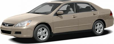 Side profile of a four-door sedan with alloy wheels and beige paint.