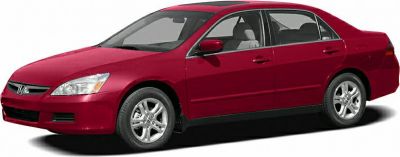 Red four-door sedan with alloy wheels and aerodynamic shape