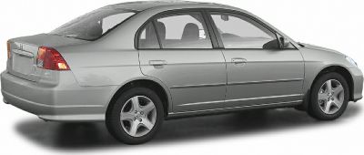 Silver four-door sedan with five-spoke alloy wheels and rear side view
