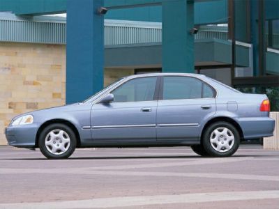 Mid-90s compact sedan side profile with alloy wheels