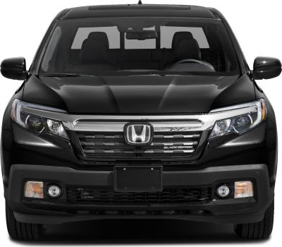 Front view showcasing grille and headlights of a pickup.