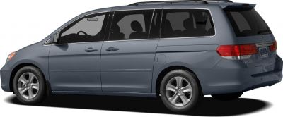 Side profile of minivan with sliding doors and alloy wheels